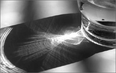 Photograph of light shining onto a table through a glass