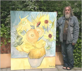 Photo of artist standing next to his painting of Van Gogh's Sunflowers